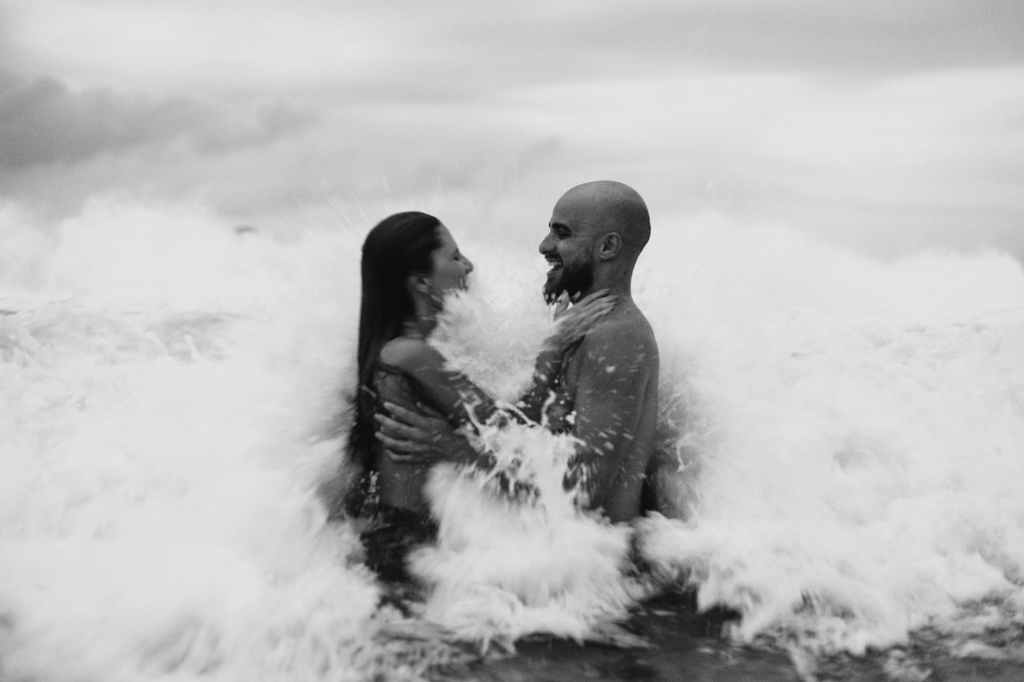monochrome photo of couple in ocean