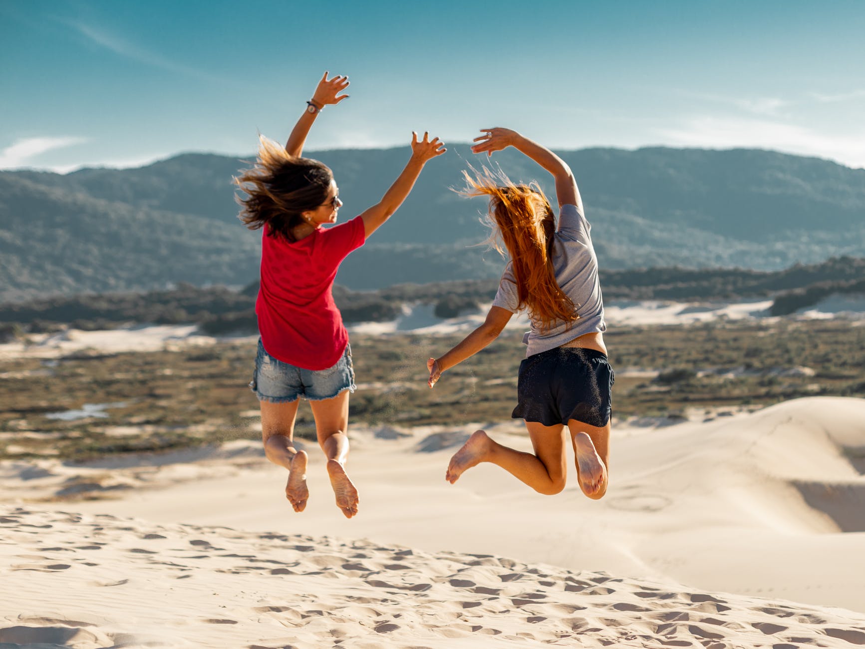 jump shot photography of two women