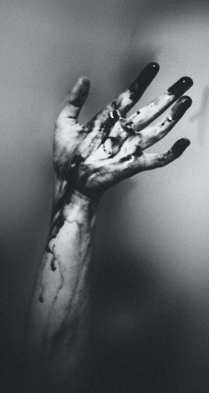 photo of hand with dark paint